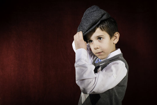Smiling child in vintage clothes and hat