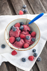 Berry ice cream decorated with fresh blueberries and raspberries