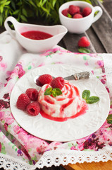 Delicious dessert with raspberry sauce and fresh berries