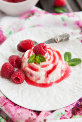 Delicious dessert with raspberry sauce and fresh berries