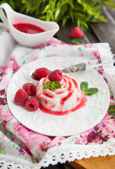 Delicious dessert with raspberry sauce and fresh berries