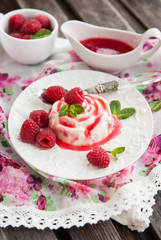 Delicious dessert with raspberry sauce and fresh berries