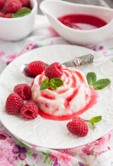 Delicious dessert with raspberry sauce and fresh berries