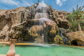 one woman bathing ma'in hot springs waterfall jordan