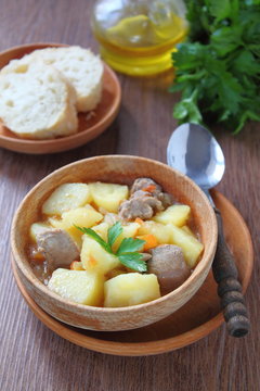 vegetables stewed with meat in a wooden plate