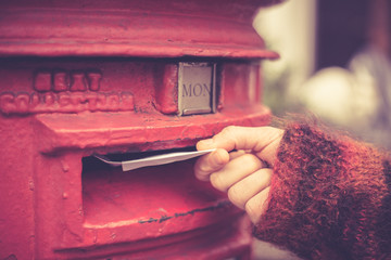 Woman posting letter - 61707216