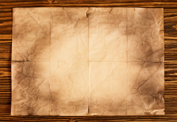 Old paper on brown wooden background