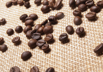 Coffee beans on burlap background