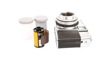 Old retro analog camera with new film roll over white background