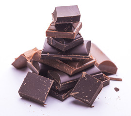Roughly cut chunks of a chocolate bar on the white