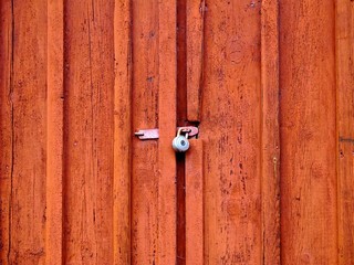Old red door with a padlock.