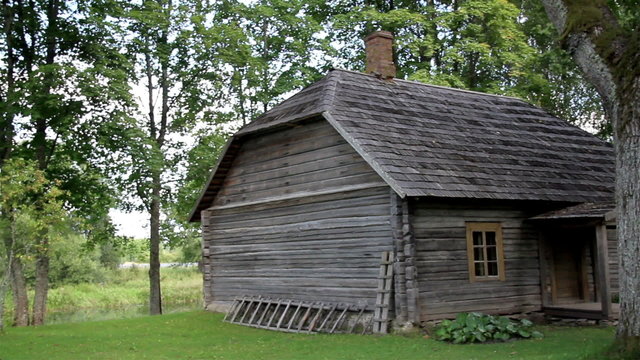 The old wooden log house made in lumbers surrounded with trees