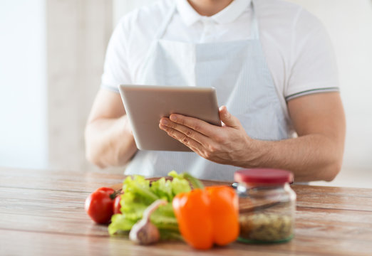 closeup of man reading recipe from tablet pc