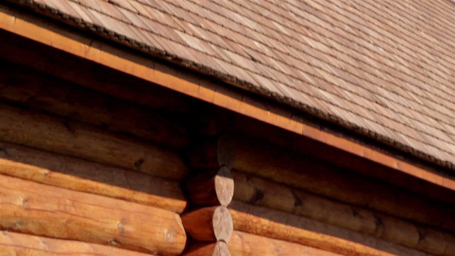 Brown colored log house wall with tar oiled cedar