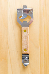 Can opener on wood background