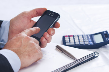 Businessman working in the office with mobile phone