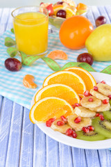 Sweet fresh fruits on plate on table close-up
