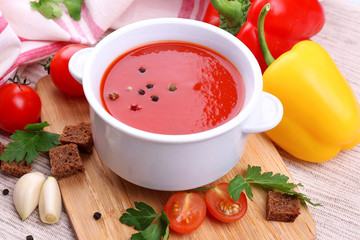 Tasty tomato soup and vegetables, close up
