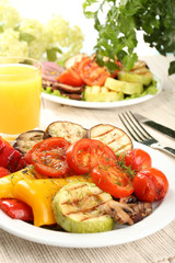 Delicious grilled vegetables on plate on table close-up