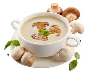 Mushroom soup in white bowl, on plate, isolated on white