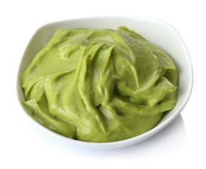 Fresh guacamole in bowl isolated on white