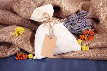 Textile sachet pouch with dried flowers, herbs and berries