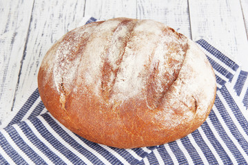 Rye bread on napkin on wooden background