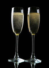 Glasses of champagne, on black background