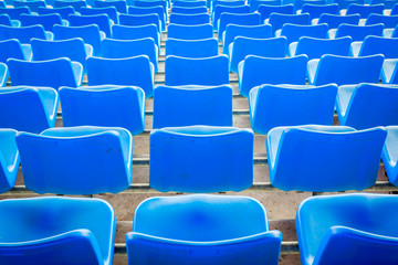 Empty dark blue chairs at the football Stadium