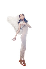 Charming curly brunette posing in angel costume