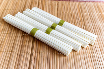 Rice noodles on a bamboo napkin