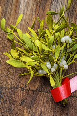 mistletoe branch on a wooden background