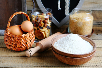 flour in a bowl and eggs in basket