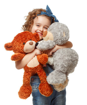 Little girl holding a teddy bear. Isolated on white background