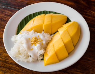 Thai style tropical dessert, glutinous rice eat with mangoes