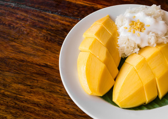 Thai style tropical dessert, glutinous rice eat with mangoes
