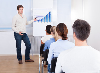 Young Man Explaining Graph