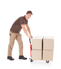 Delivery Man Standing Near Boxes And Hand truck