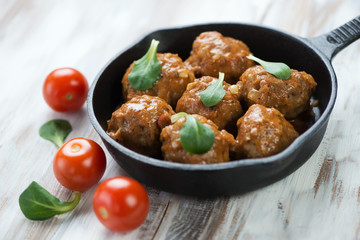 Close-up of meatballs with tomato sauce, horizontal shot