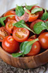 Close-up of fresh cherry tomatoes and corn salad leaves