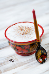 Buckwheat with milk in a wooden khokhloma bowl