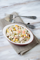 Above view of olivier salad over wooden background