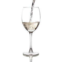 white wine pouring into a glass