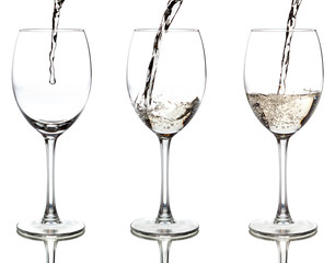 white wine pouring into a glass