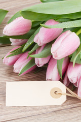 pink tulips with empty tag