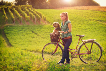 Fototapeta premium Young women in a country with her dog