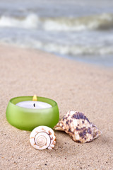 sea shell and candle romantic set on the beach