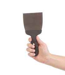 Hand holds construction spatula.