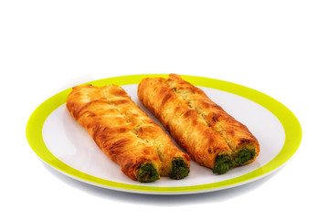 Puff pastry bun isolated on white dish. Healthy patty with spina