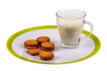 Full glass of milk and cookies on the plate
